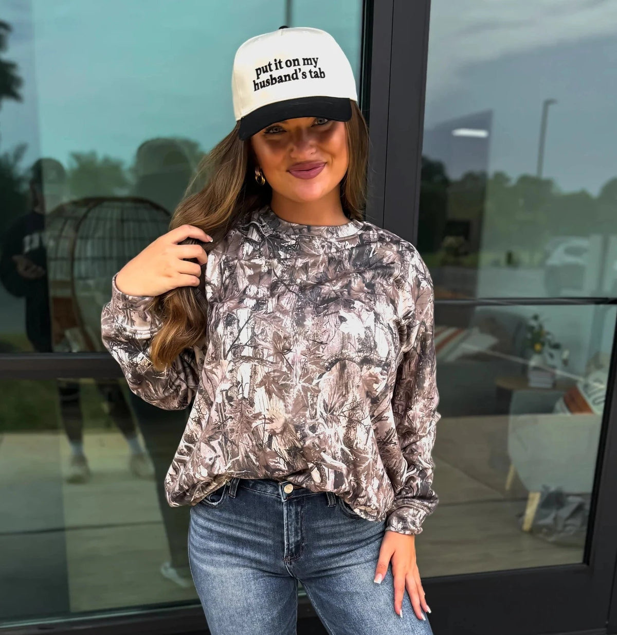 Woman wearing a camouflage long sleeve dri fit tee.