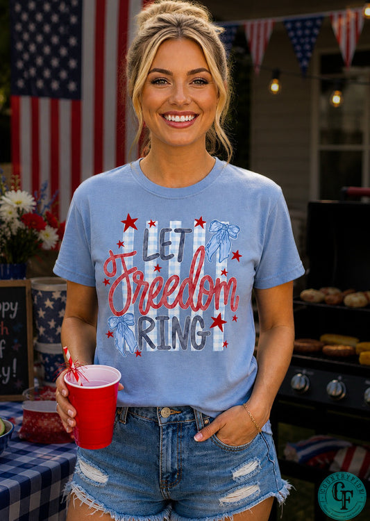 Woman wearing a 'Let Freedom Ring' t-shirt at a 4th of July celebration.